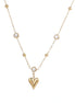 Delicate gold-plated necklace with bezel-set crystals and small heart pendant on beige background