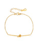 Delicate gold chain bracelet with minimalist bar and centered knot detail on cream background