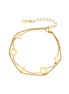 Double-layer gold-plated bracelet with quatrefoil and star charms on cream background, 18K gold finish.