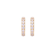 Gold pavé hoop earrings with two freshwater pearls nestled inside the curved design, featuring crystal-studded outer edge.