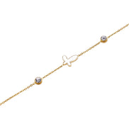 Gold chain bracelet with white mother of pearl butterfly pendant and two bezel-set crystals on cream background